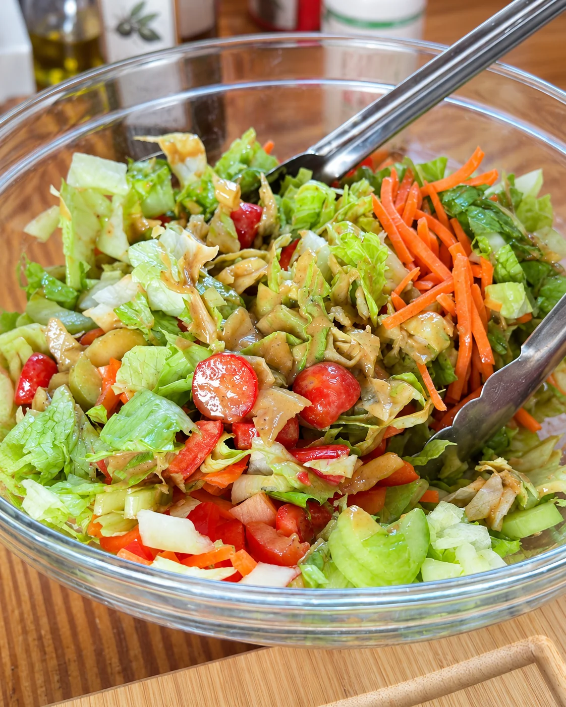 Eric’s Skinny Italian Balsamic Salad with chopped greens, cucumber, tomatoes, carrots, and dressing